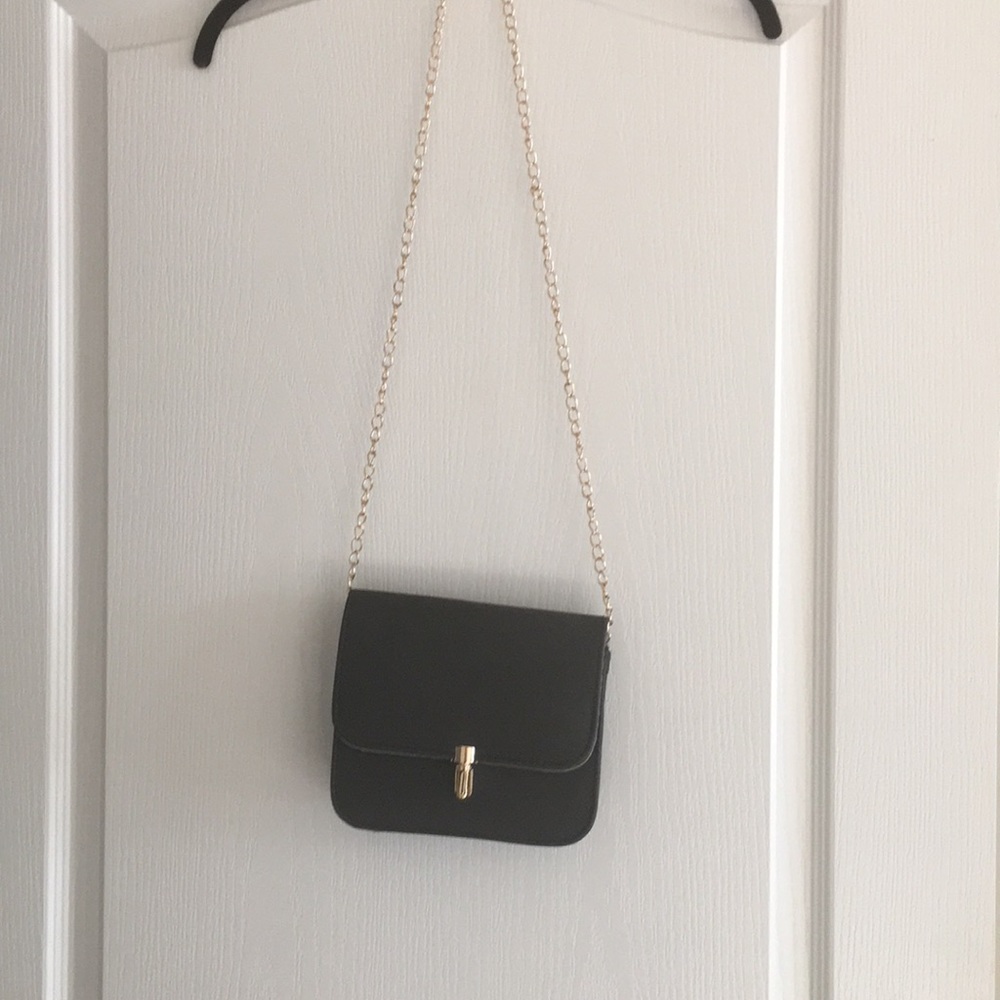 Black crossbody bag with gold chain